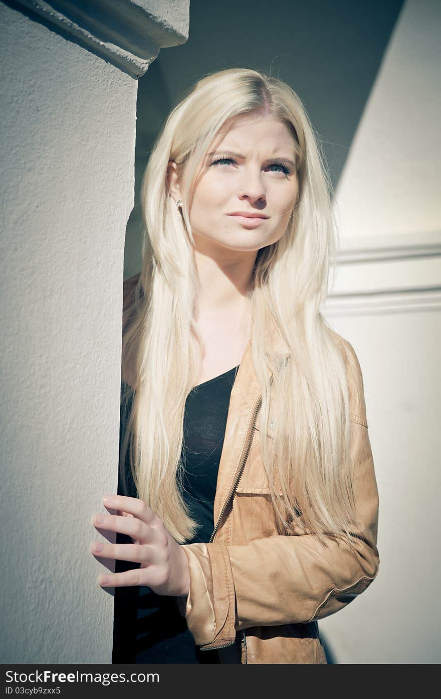 Young Blonde Woman standing beside a Column. Young Blonde Woman standing beside a Column