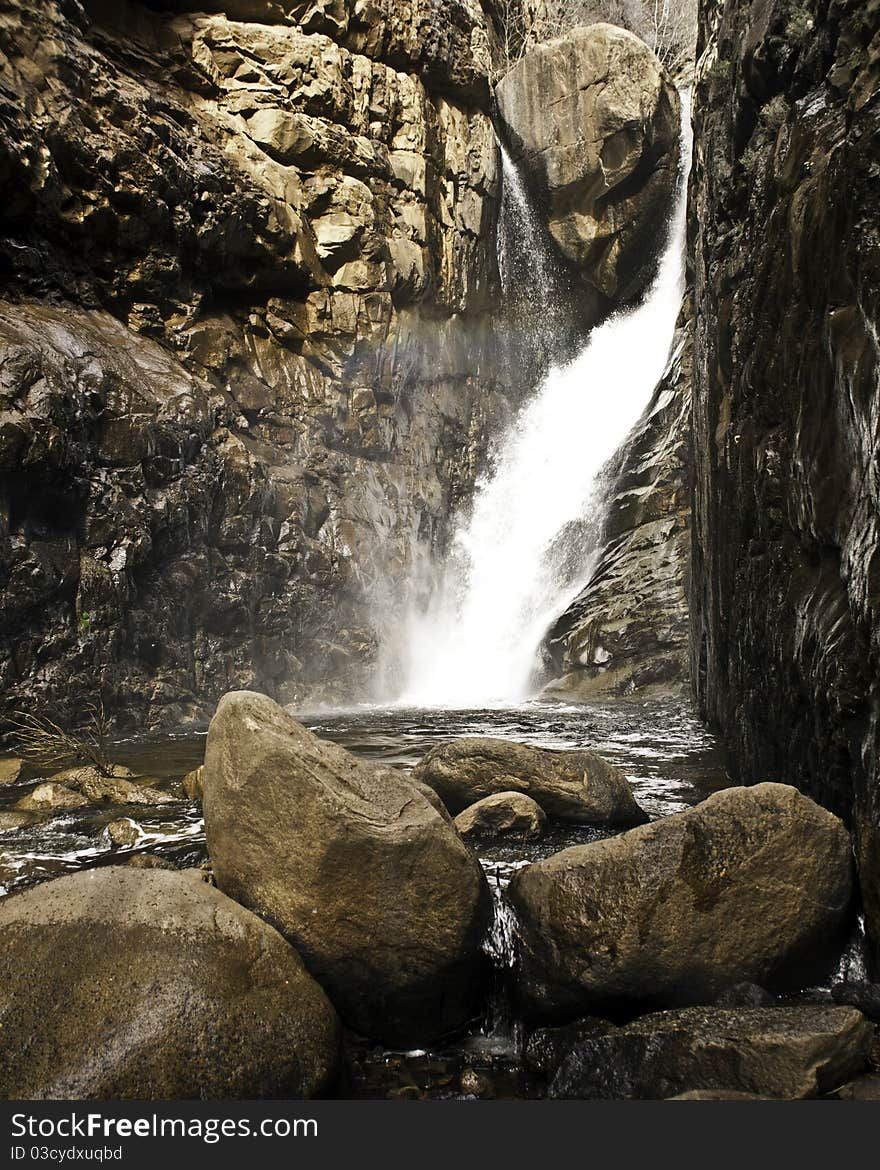 Late season snow melt furnishes this secluded waterfall and roars through a pristine slot canyon. Late season snow melt furnishes this secluded waterfall and roars through a pristine slot canyon.