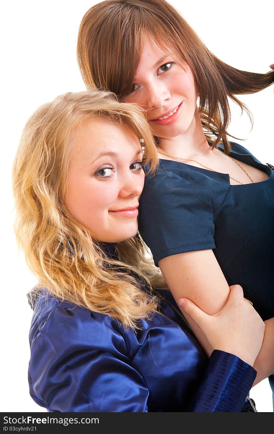 Two young girl friends smiling - isolated over white background.