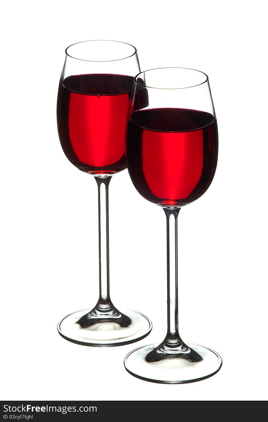 Wine glasses filled with wine. White background. Studio shot.