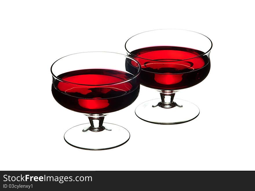 Wine glasses filled with wine. White background. Studio shot.