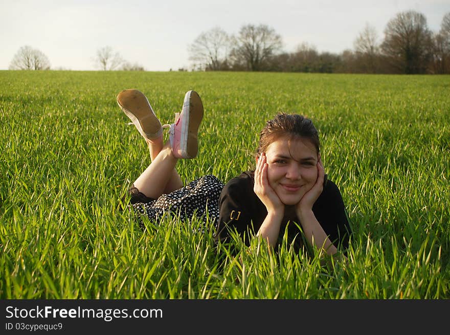 Young girl on the spring green grass. Young girl on the spring green grass