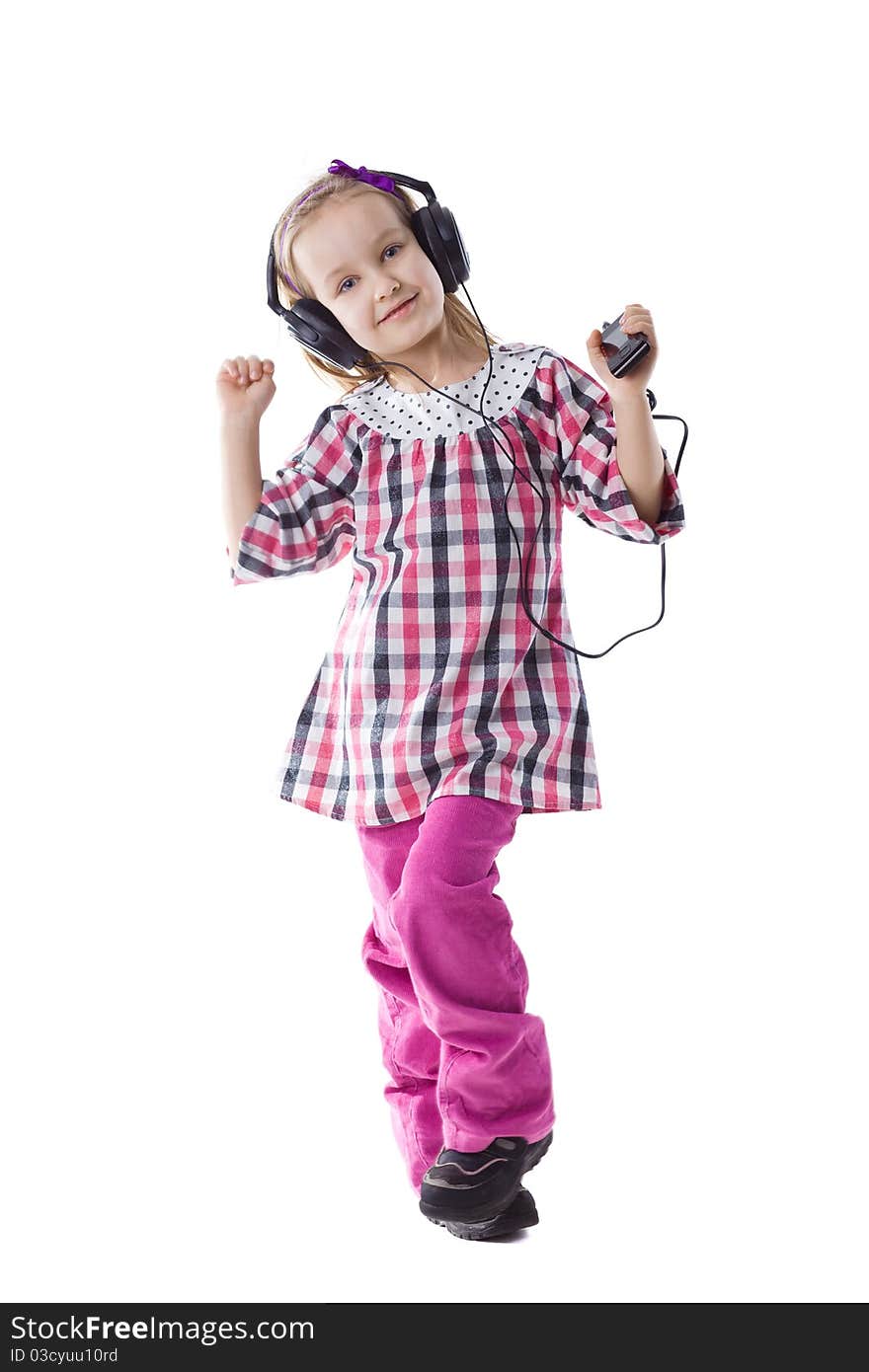 The little girl listens to music and dances. The little girl listens to music and dances