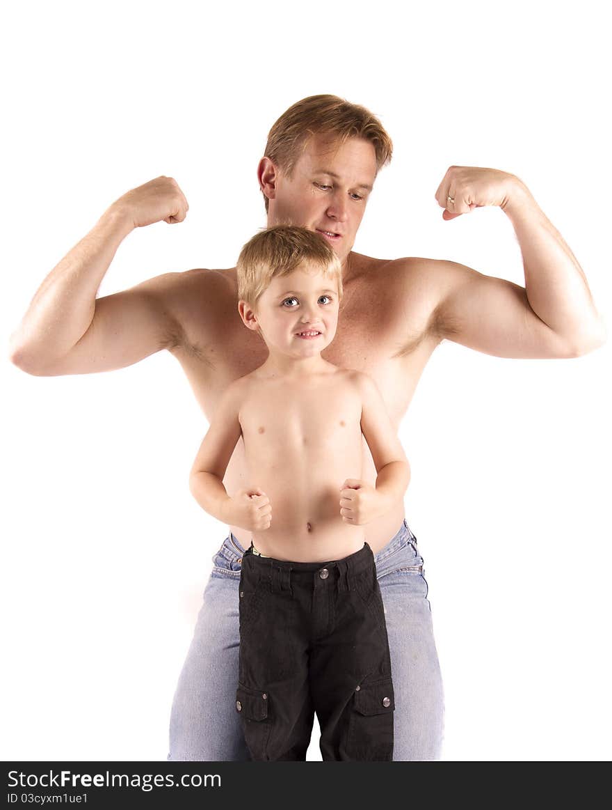 Father and son showing their muscles off. Father and son showing their muscles off