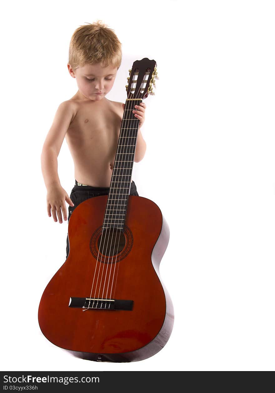 Boy playing a big guitar isolated on a white background. Boy playing a big guitar isolated on a white background