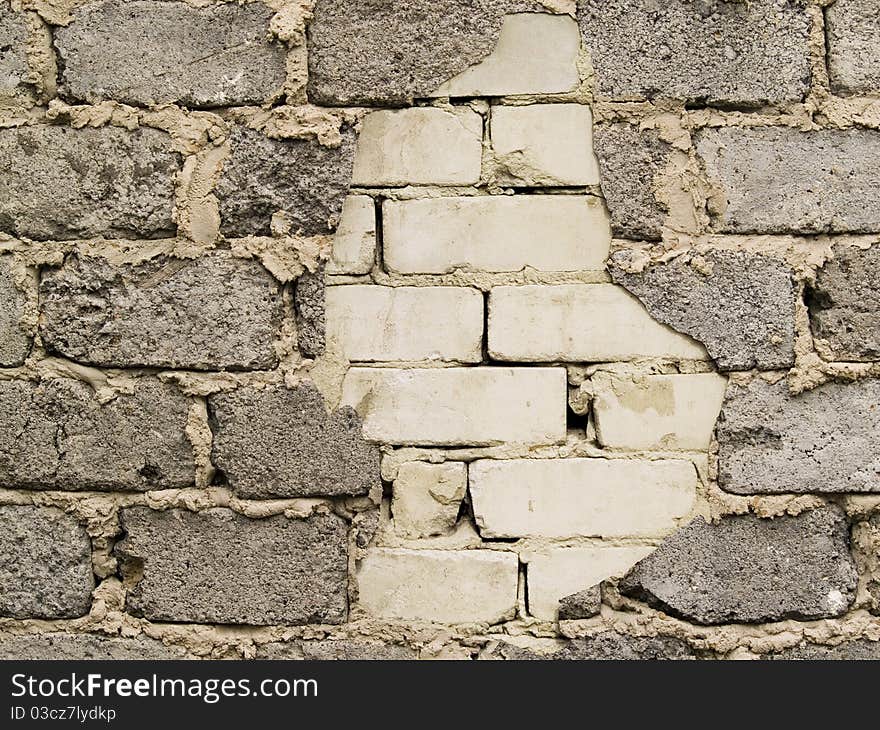 Through a hole in a wall it is visible bricks. Through a hole in a wall it is visible bricks