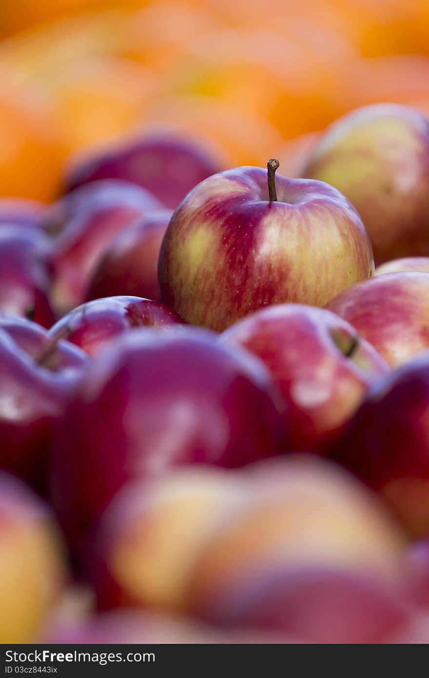 Close up on an apple in a street market table. Close up on an apple in a street market table.