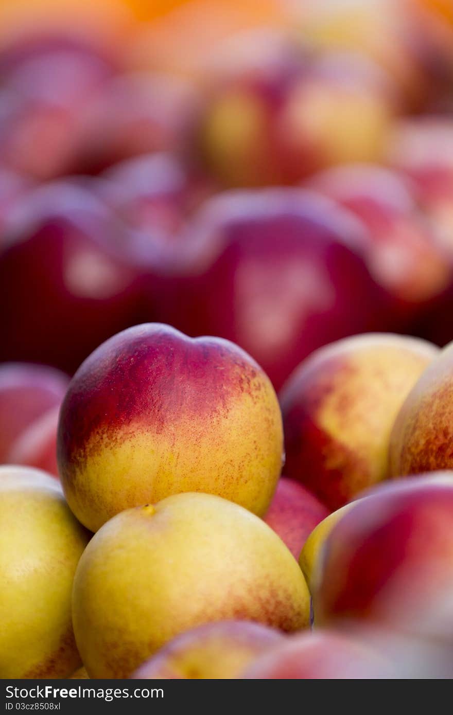 Close up on a peach in a pile.