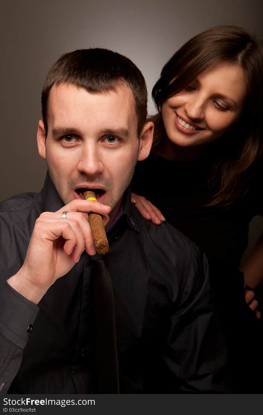 Closeup portrait of a young beautiful couple over a background