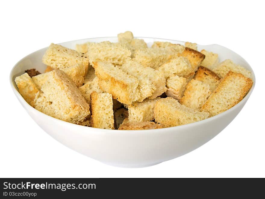 Crispy croutons in a white dish isolated on white. Clipping path included. Crispy croutons in a white dish isolated on white. Clipping path included.