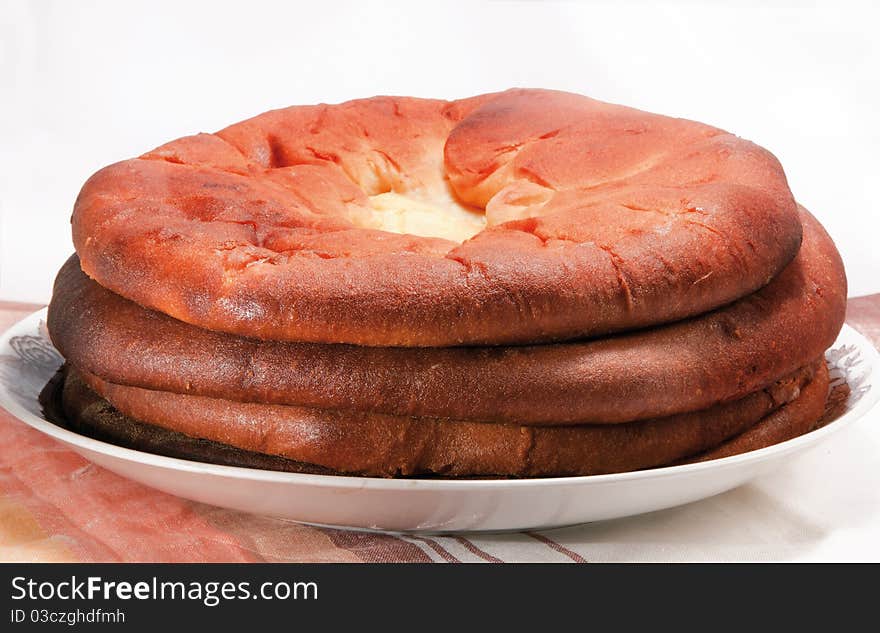 Pies with cheese and a potato,  four on a plate on a light background. Pies with cheese and a potato,  four on a plate on a light background