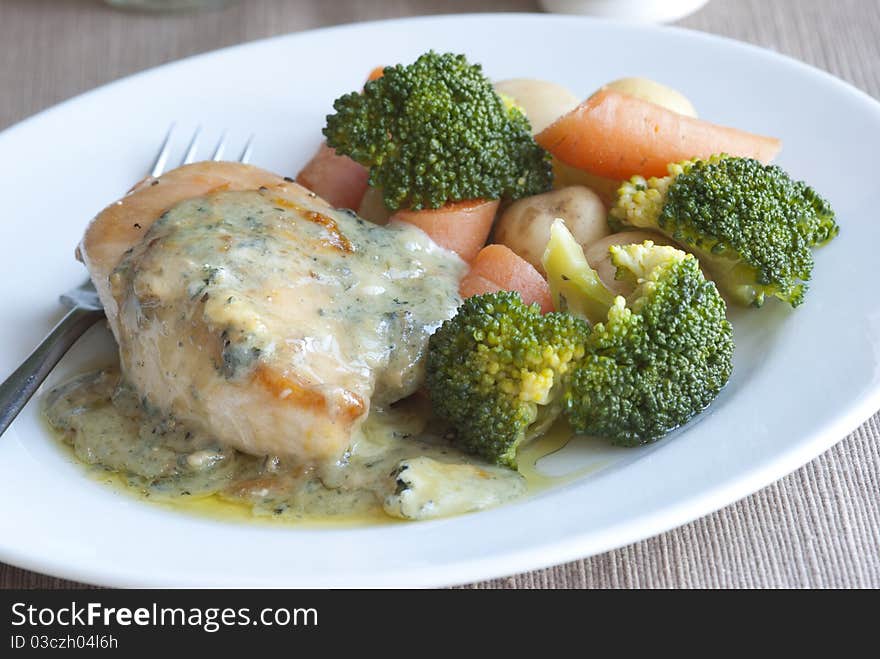 Pan-fried chicken breast with creamy basil sauce and vegetables. Pan-fried chicken breast with creamy basil sauce and vegetables