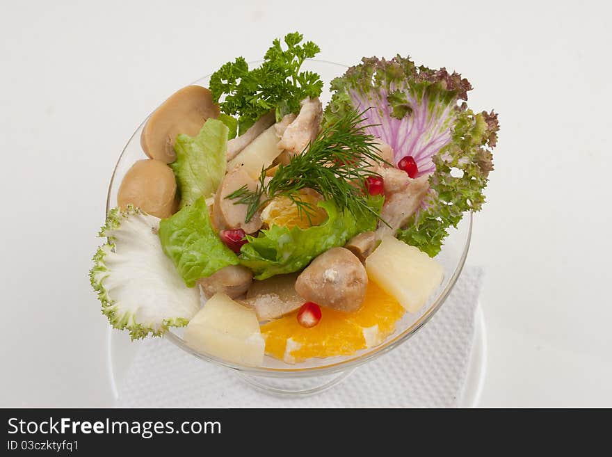 Salad with fruits and greens, studio isolated shot