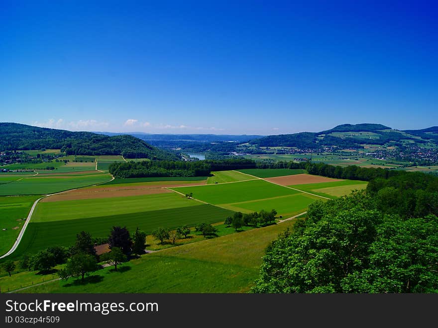 Farm field cultivated with green blocks and wonderful blue sky. Farm field cultivated with green blocks and wonderful blue sky