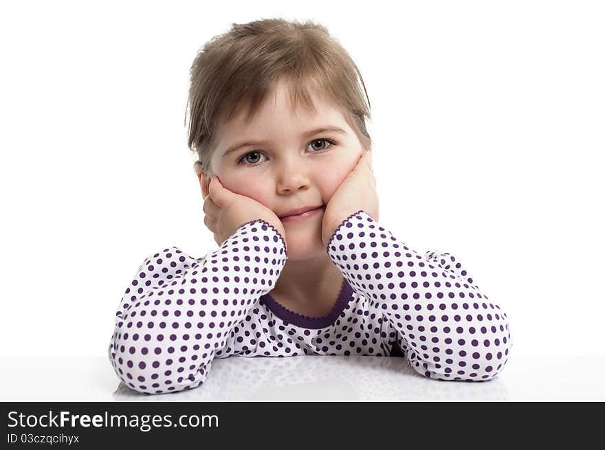 Little girl set her elbows against the desk. Little girl set her elbows against the desk