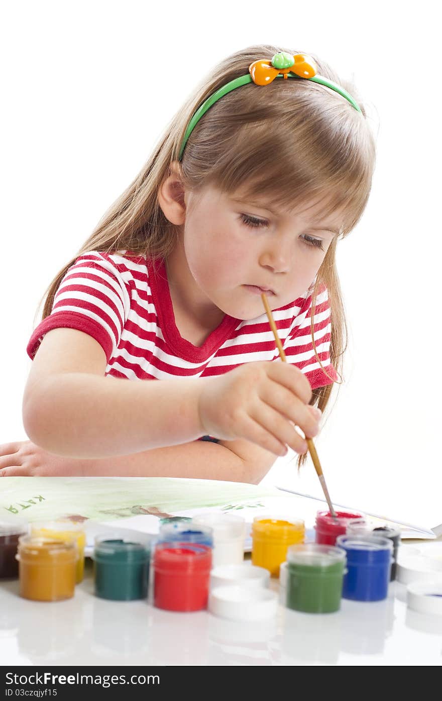 Little girl is drawing with different colors