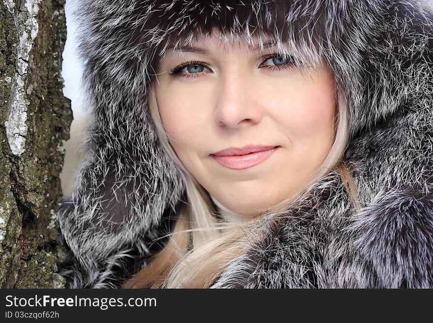 Beautiful woman in winter fur coat