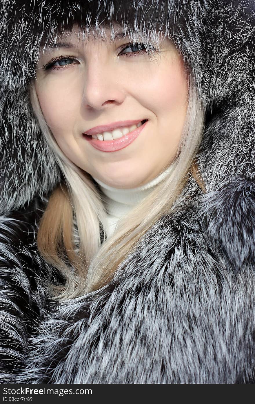 Beautiful woman in winter fur coat