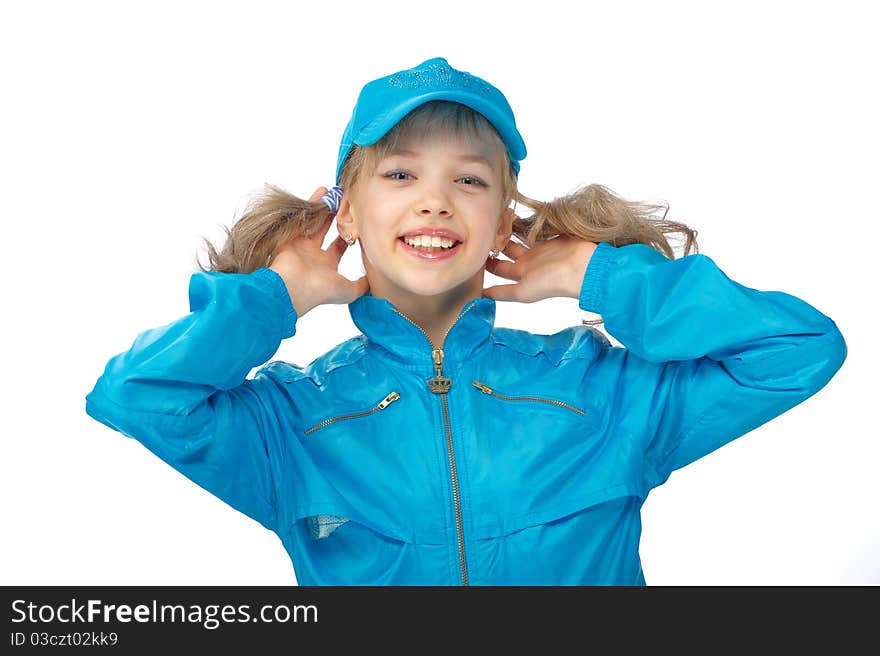 Portrait of a cute young girl standing on the blue cap and sport clothe with heaved up hands at a head over white background. Portrait of a cute young girl standing on the blue cap and sport clothe with heaved up hands at a head over white background