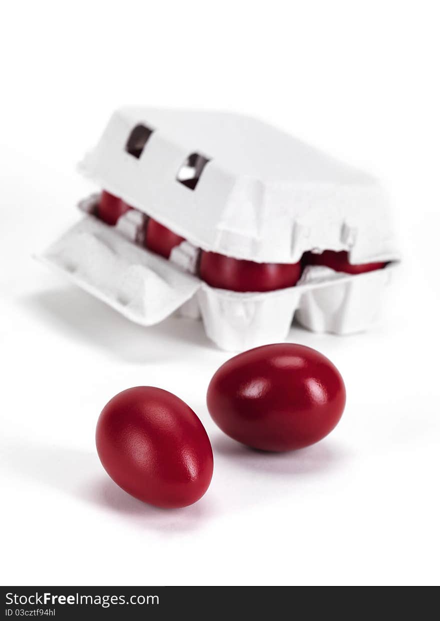 Egg carton box and two red eggs