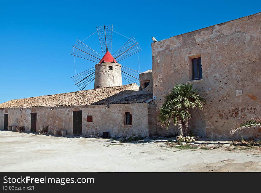 Ancient windmill located close to the saline in trapani. Ancient windmill located close to the saline in trapani