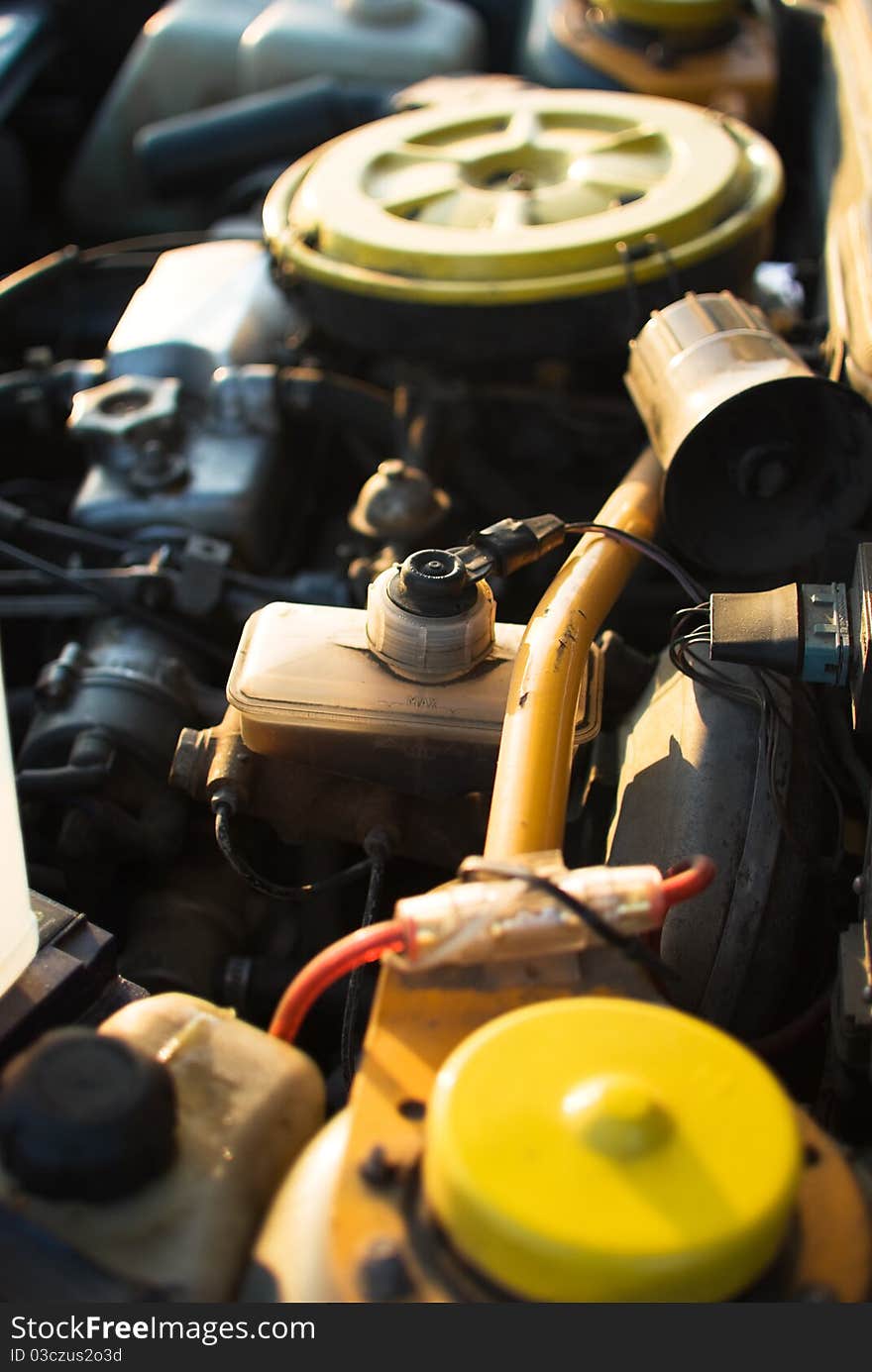 Blue toned image of engine under the hood of a car