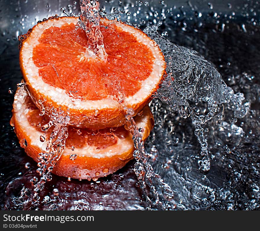 Water splashing over two oranges. Water splashing over two oranges