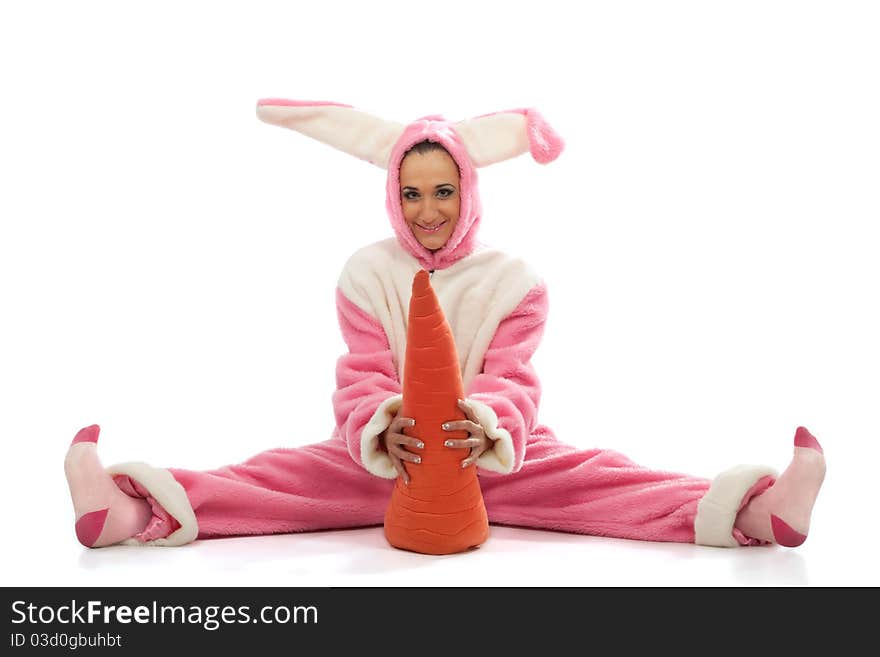 Funny pink rabbit with big carrot isolated on white background