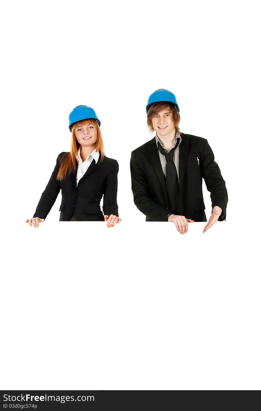 Business man and business woman holding board with helmets on over white background. Business man and business woman holding board with helmets on over white background