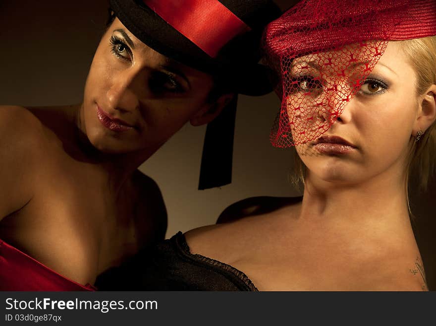 Lovely cabaret performers on stage isolated on dark background