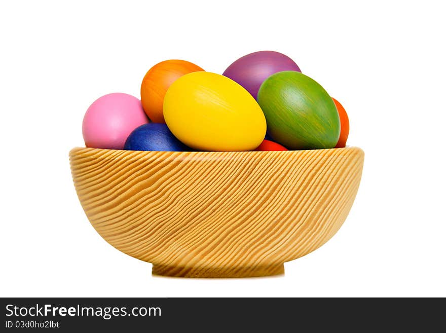 Colorful Easter eggs in wooden bowl