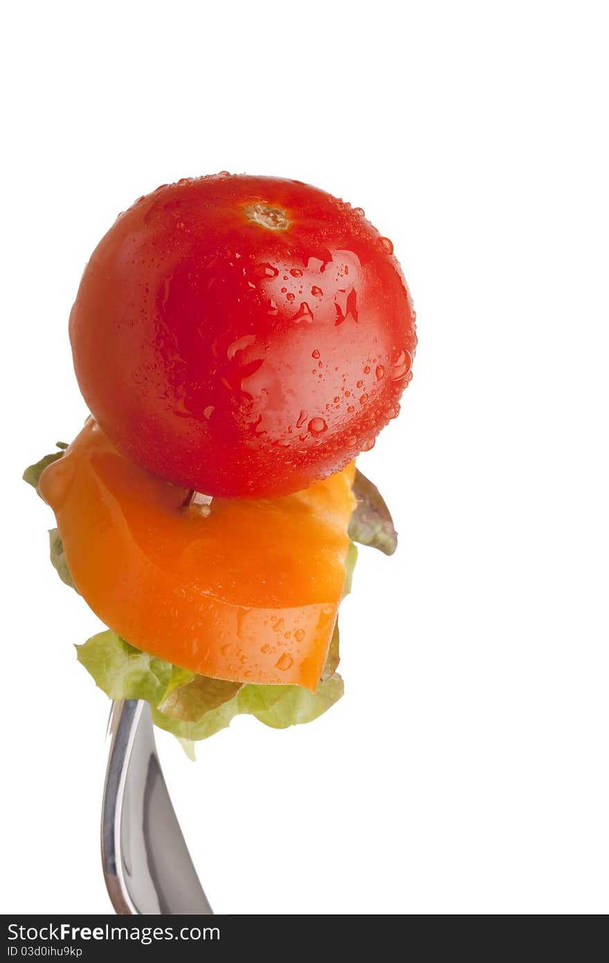 Sandwich of tomato, peppers and lettuce on a fork. Sandwich of tomato, peppers and lettuce on a fork.