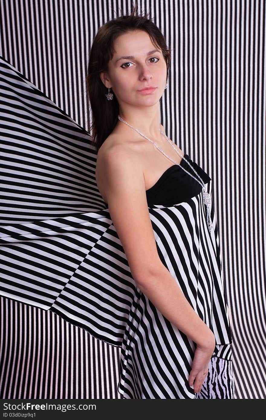 Cute girl in a striped clothes on the striped background