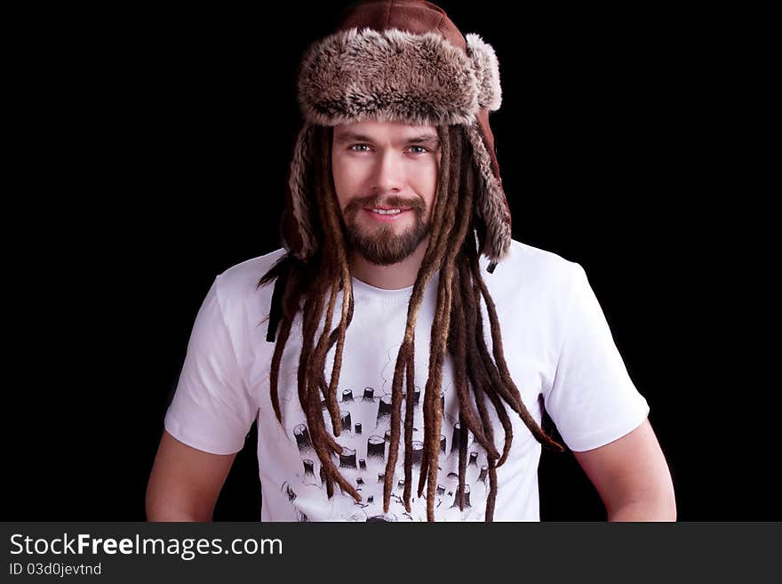 Guy with dreadlocks wearing a fur hat