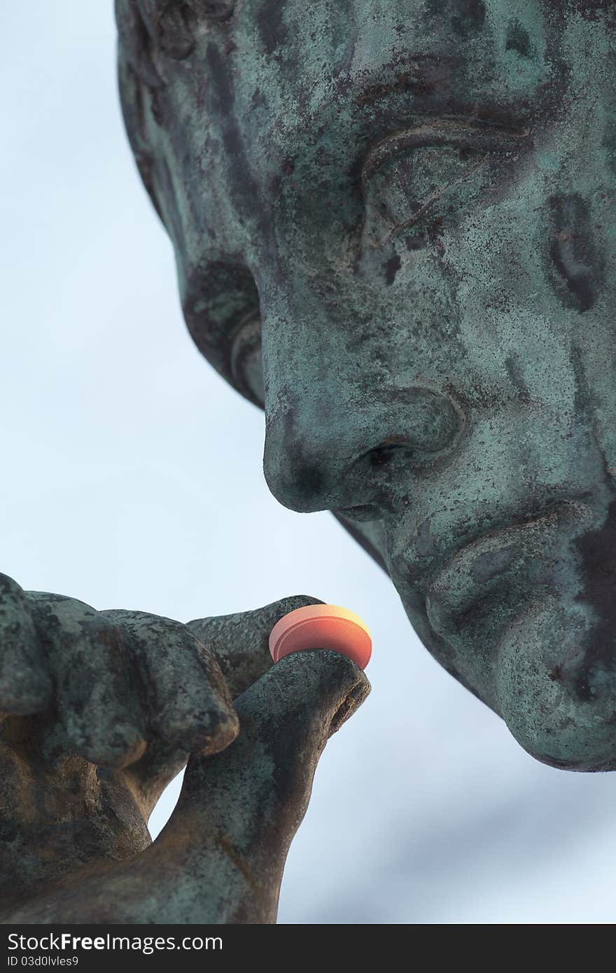 Ancient sculpture with glowing curative pill in its hand. Ancient sculpture with glowing curative pill in its hand