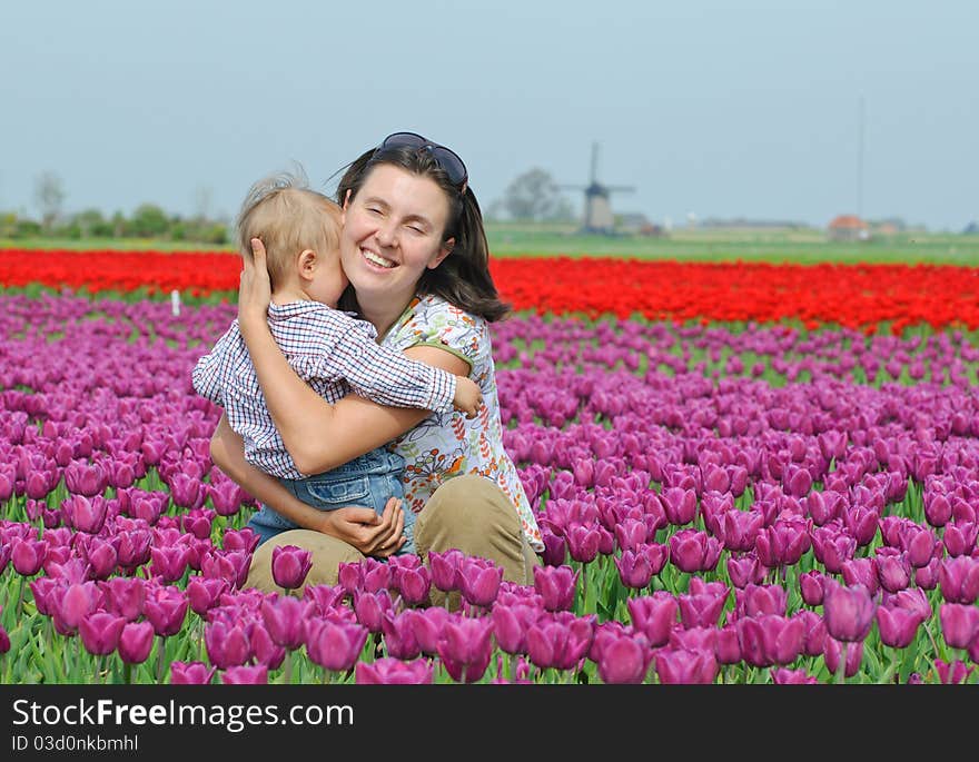 In Tulip Field. Mother with son in tulips field