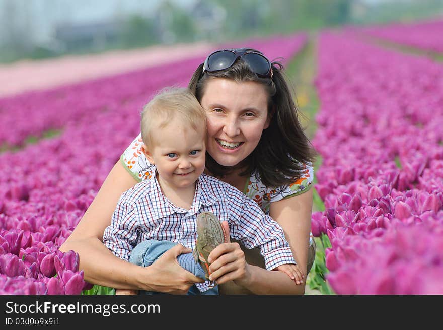 In Tulip Field. Mother with son in tulips field