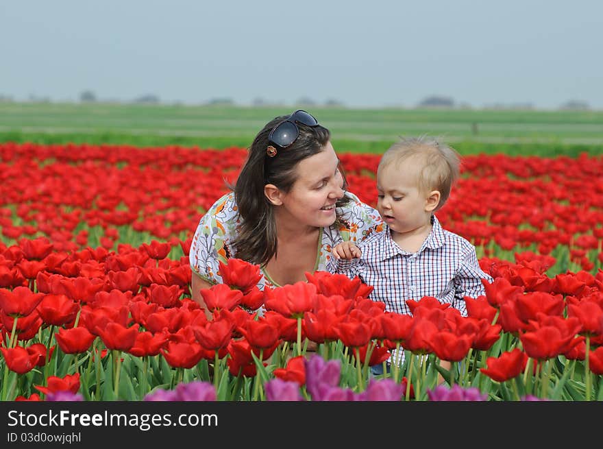 Mother with son in the red tulips field. Mother with son in the red tulips field