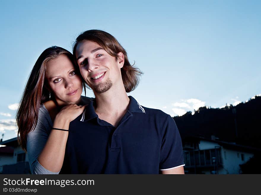 Young couple in love with blue sky in the background. Young couple in love with blue sky in the background