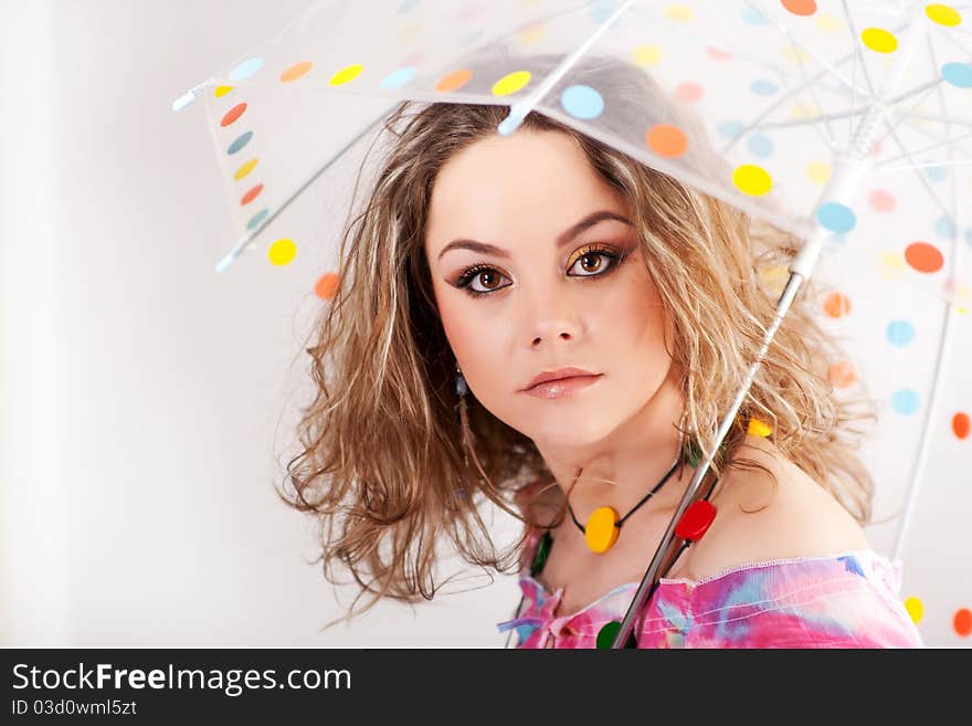 Beautifull girl under polka dotted umbrella