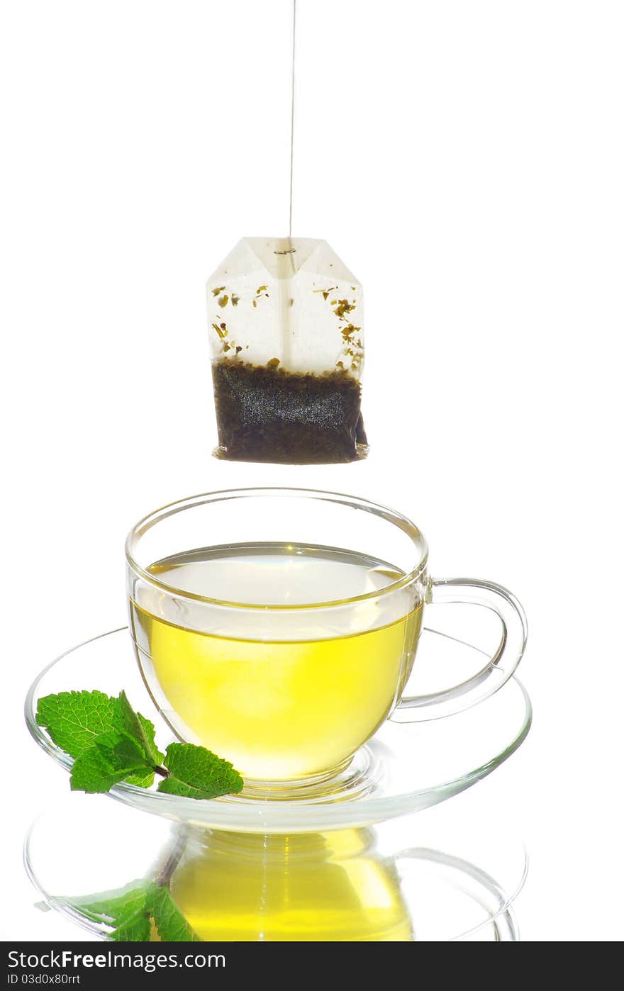 Tea in cup with leaf mint isolated on white background