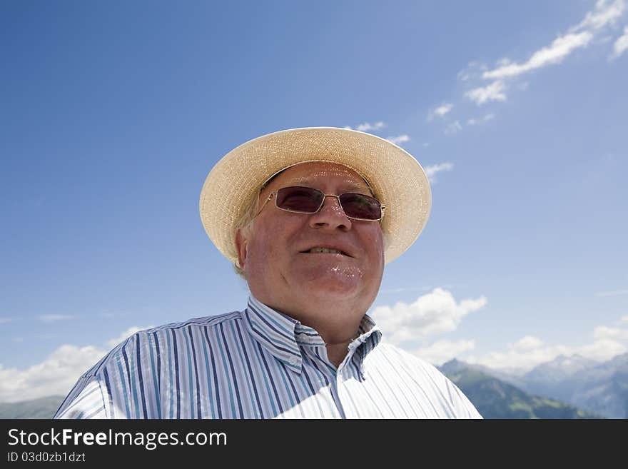 An older man with hat, staring in the distance. An older man with hat, staring in the distance