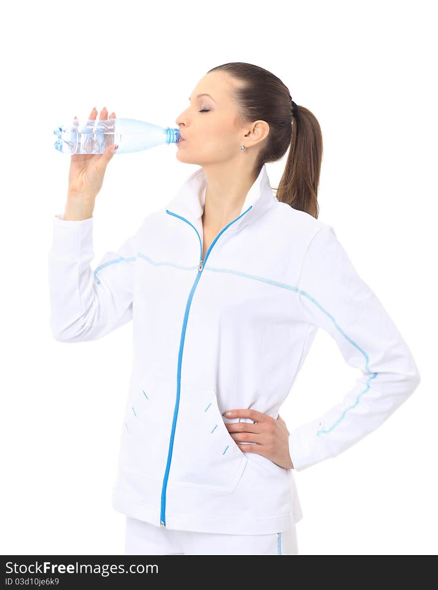 Woman in sportswear drinking water, isolated on white. Woman in sportswear drinking water, isolated on white