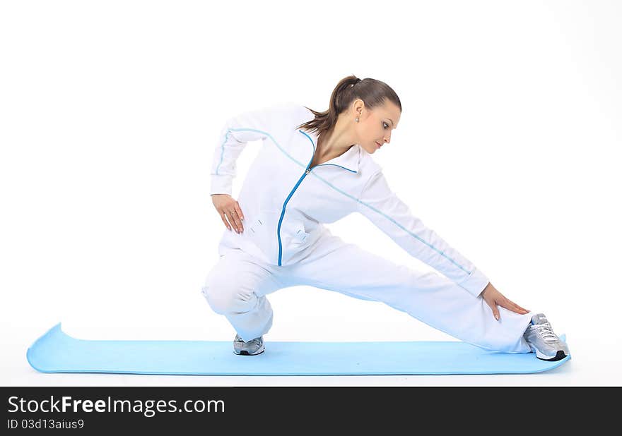 Woman doing stretching on a mat. Woman doing stretching on a mat