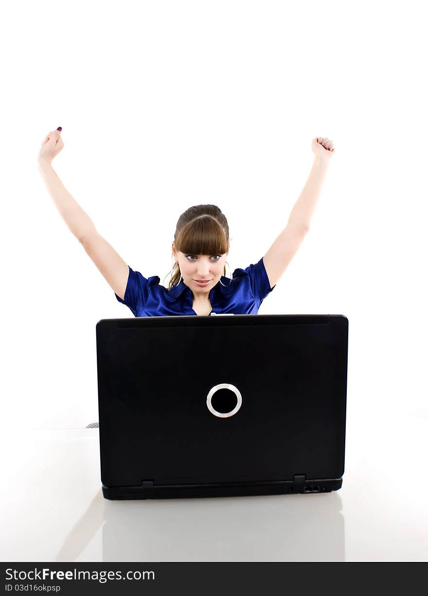 Young woman in office jubilates at desk. Isolated on white background.