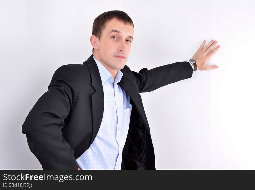 Young business Man standing at the wall