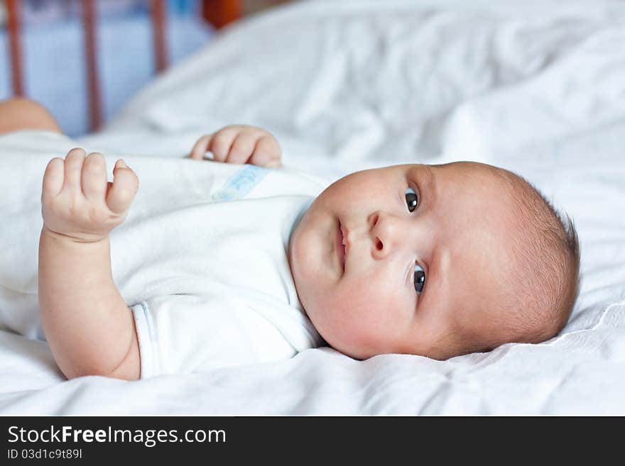 Cute little child is lying on the sheet