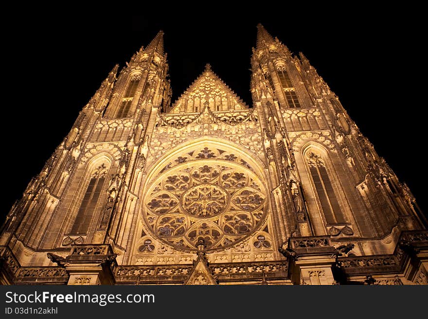 Illuminated front of saint vitus cathedral at night in Prague, Czech Republic