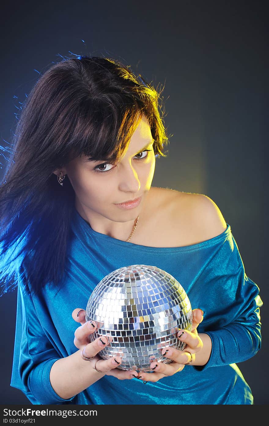 Portrait of young woman with disco ball