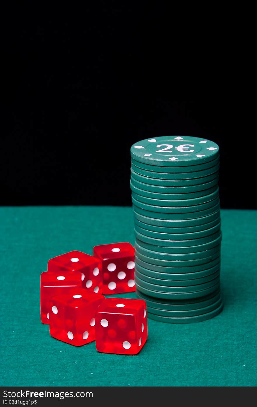 Poker Chips column with a set of dice on black background